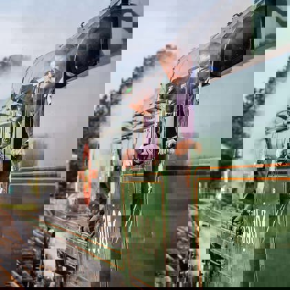 Two men standing on the footplate of a green steam train - Jack Boskett