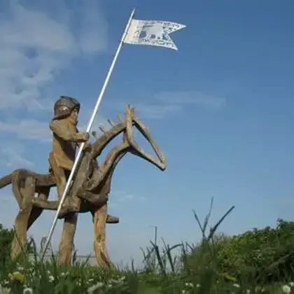 The Arrivall a wooden sculpture of a joisting man on horseback
